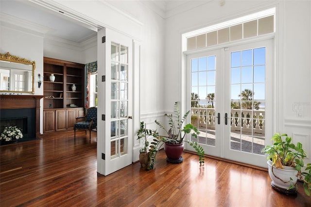 doorway to outside featuring french doors, dark hardwood / wood-style floors, built in features, and ornamental molding