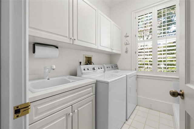 laundry room featuring cabinets, sink, washer and clothes dryer, and light tile patterned flooring