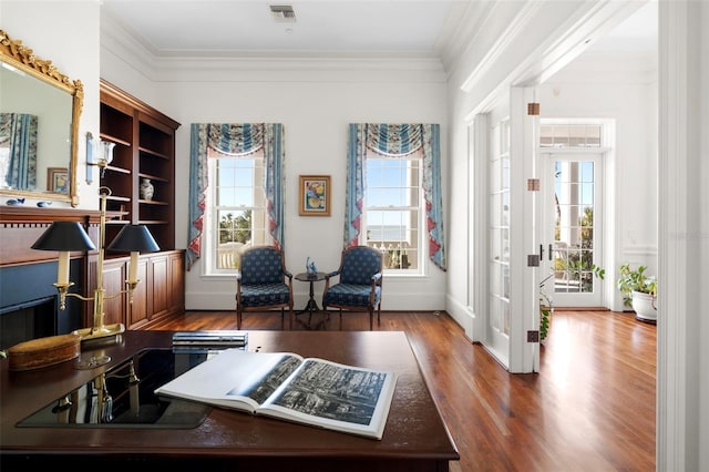 interior space with hardwood / wood-style floors and ornamental molding