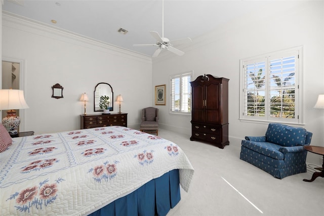 bedroom with ceiling fan, light colored carpet, and crown molding