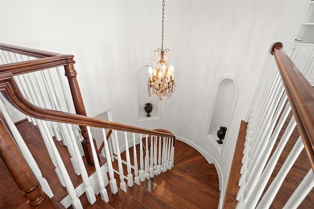 stairway with a chandelier