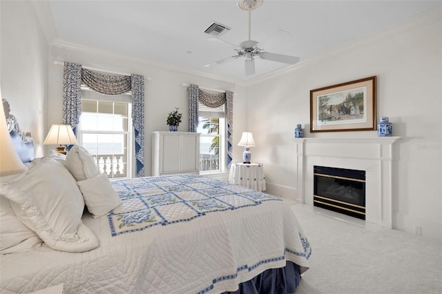 carpeted bedroom featuring ceiling fan and ornamental molding