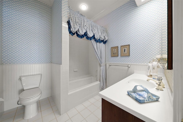 full bathroom with tile patterned floors, tiled shower / bath combo, toilet, and vanity