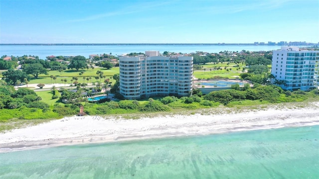 drone / aerial view featuring a beach view and a water view