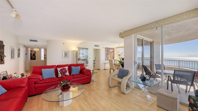 living room with wood-type flooring and a water view