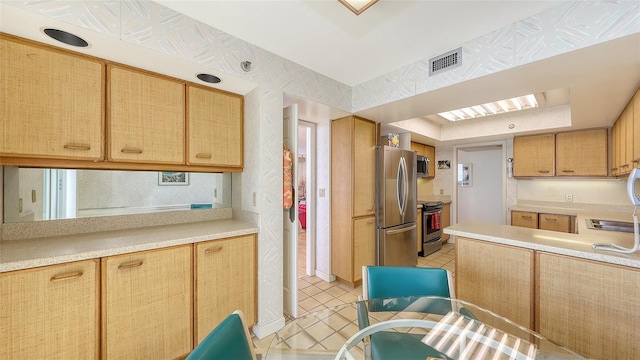 kitchen featuring light tile patterned floors and appliances with stainless steel finishes