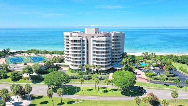 birds eye view of property with a water view and a view of the beach