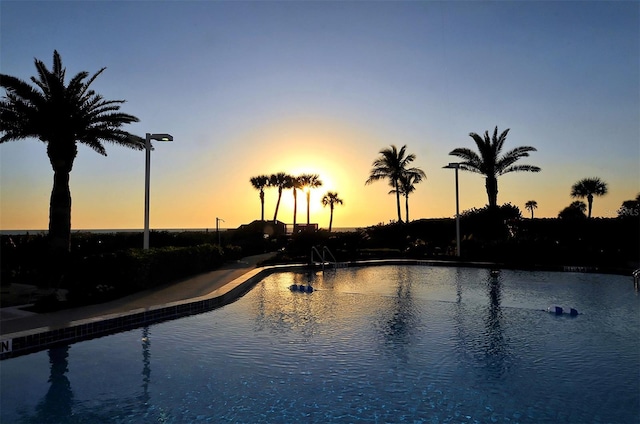 pool at dusk with a water view