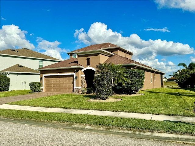 view of front of house featuring a front lawn and a garage