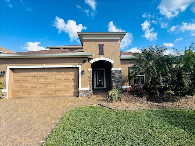 view of front of home with a garage and a front lawn