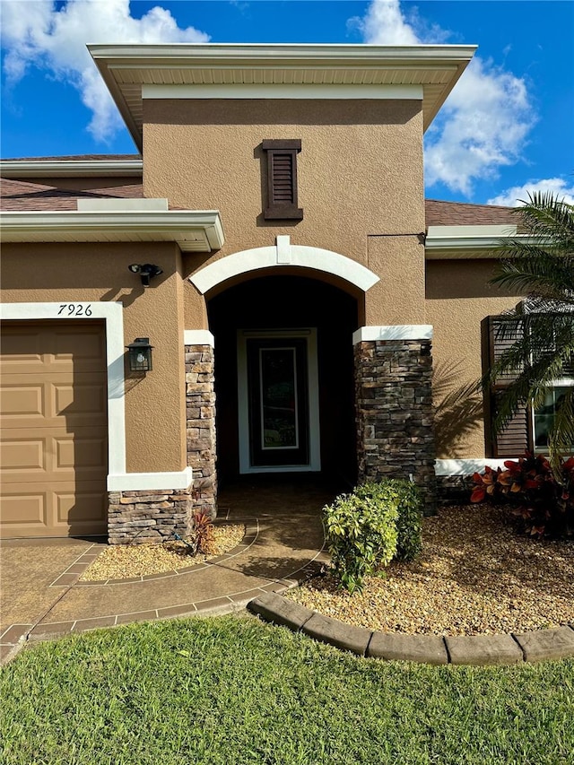 doorway to property featuring a garage