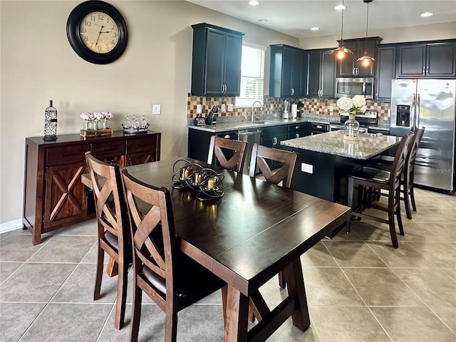 dining room featuring light tile patterned flooring and sink