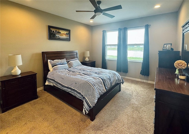 bedroom featuring light carpet and ceiling fan