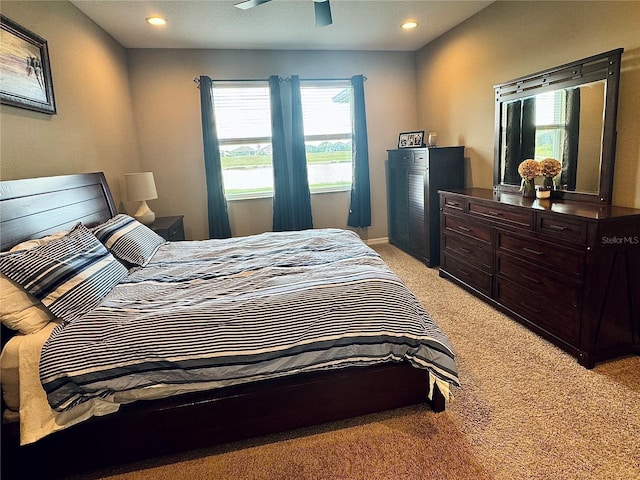 bedroom with ceiling fan and light colored carpet