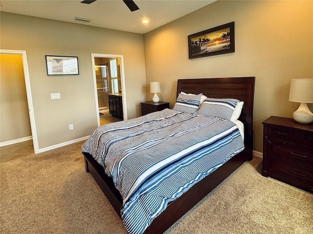 carpeted bedroom featuring ceiling fan and ensuite bath