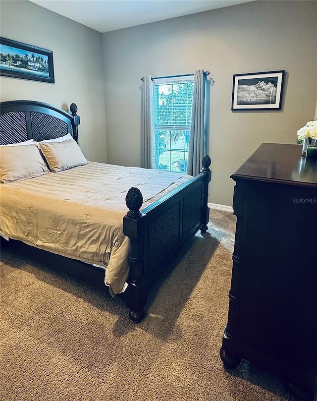 bedroom featuring dark carpet