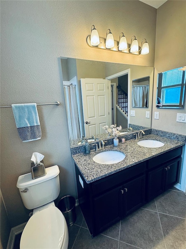 bathroom with tile patterned floors, vanity, and toilet