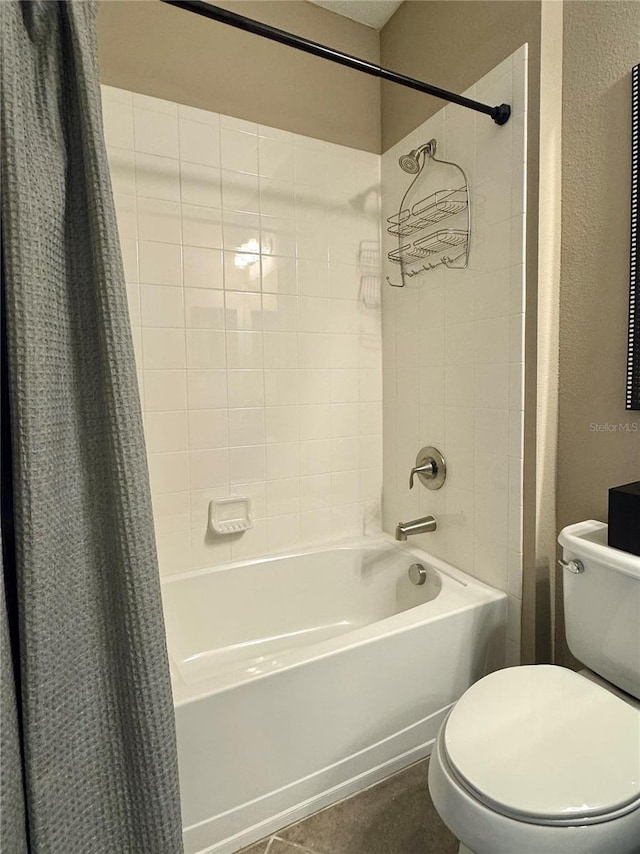 bathroom with tile patterned floors, shower / tub combo, and toilet