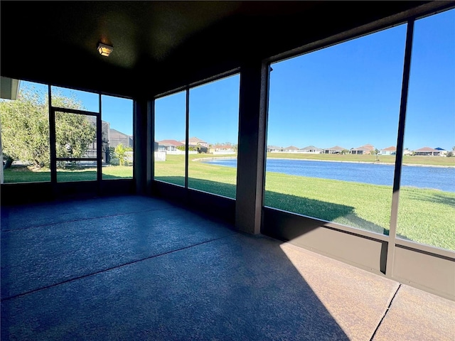 unfurnished sunroom featuring a water view