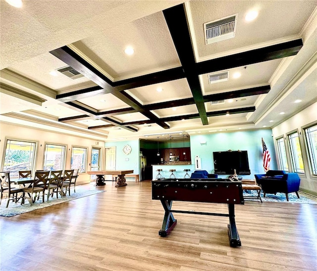 recreation room featuring ornamental molding, coffered ceiling, a textured ceiling, beam ceiling, and light hardwood / wood-style floors