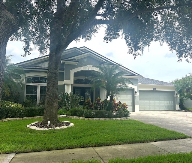 view of front of house featuring a front lawn and a garage