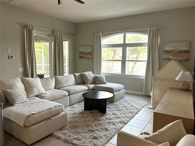 living room featuring ceiling fan and light tile patterned flooring