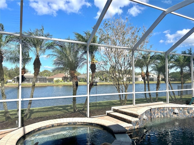 view of pool with a lanai, a jacuzzi, and a water view