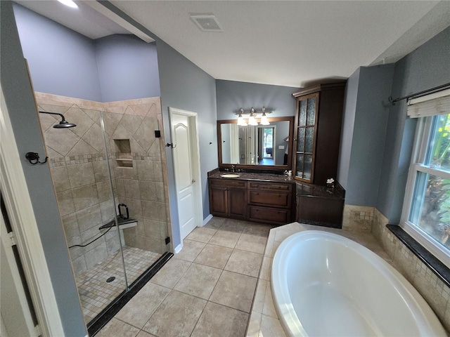 bathroom featuring vanity, tile patterned flooring, vaulted ceiling, and plus walk in shower