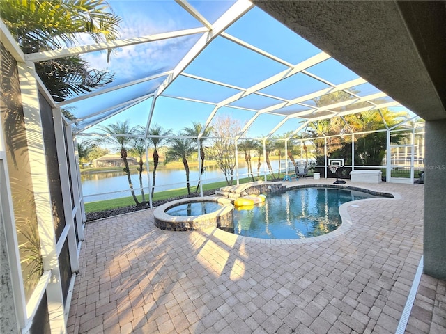 view of swimming pool with a patio area, glass enclosure, an in ground hot tub, and a water view