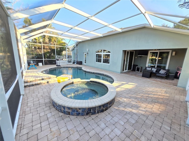 view of pool with a lanai, an in ground hot tub, and a patio area