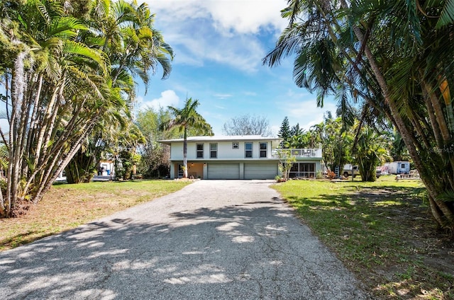 view of front of property featuring a garage and a front lawn