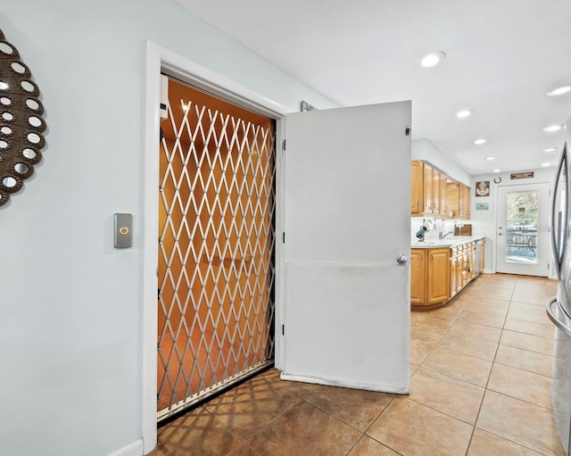 kitchen featuring dishwasher and light tile patterned flooring