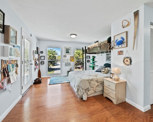 bedroom with access to outside and light hardwood / wood-style flooring