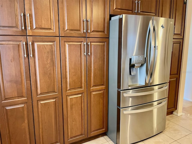 kitchen with stainless steel fridge with ice dispenser and light tile patterned floors