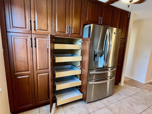 kitchen featuring stainless steel fridge and light tile patterned floors