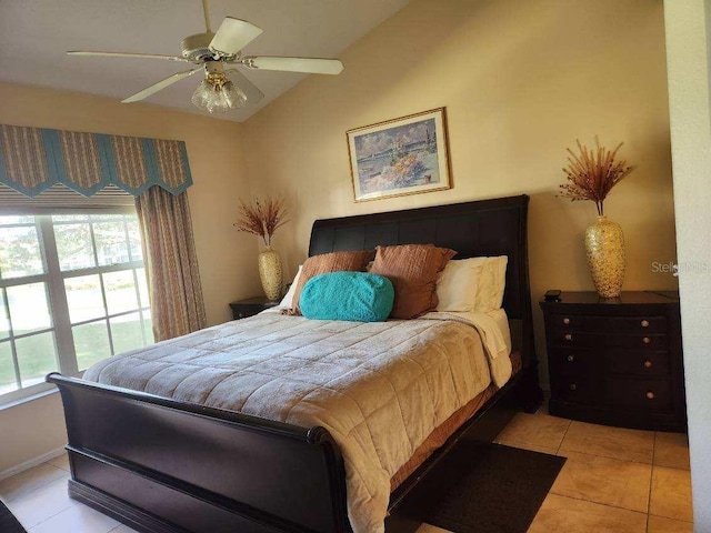 bedroom featuring vaulted ceiling, ceiling fan, and light tile patterned flooring