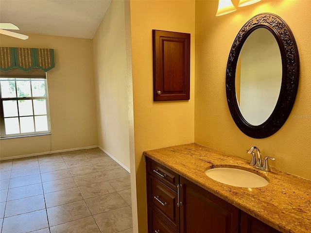 bathroom with tile patterned flooring, vanity, and ceiling fan