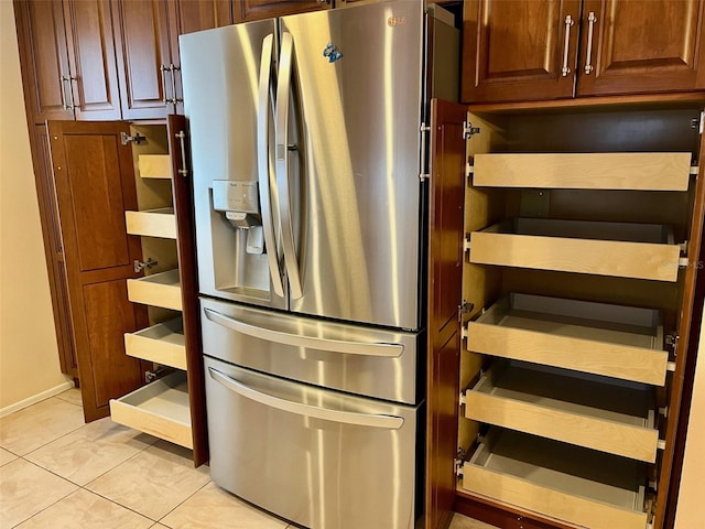 kitchen with light tile patterned floors and stainless steel refrigerator with ice dispenser