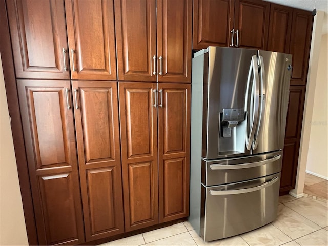 kitchen featuring stainless steel fridge with ice dispenser and light tile patterned floors