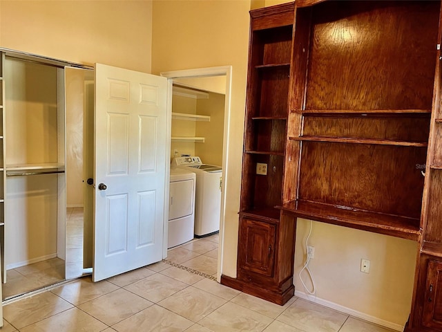 interior space featuring light tile patterned flooring and separate washer and dryer