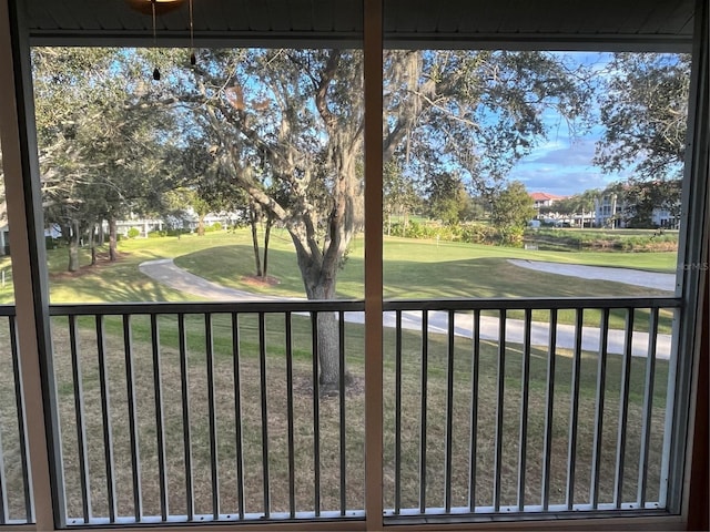 view of gate with a lawn