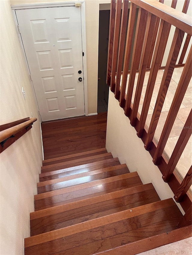 stairs featuring wood-type flooring