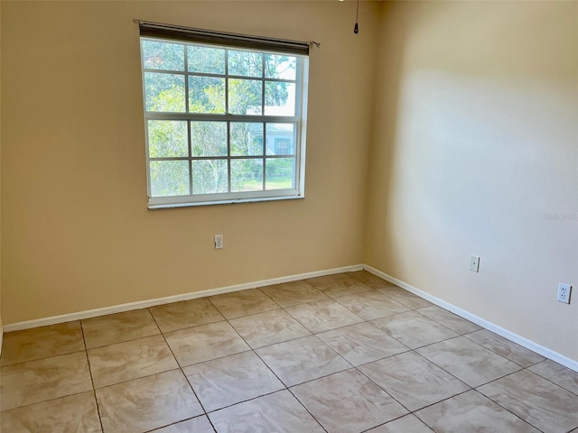 unfurnished room featuring light tile patterned floors