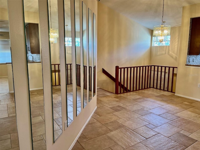 unfurnished room with a chandelier