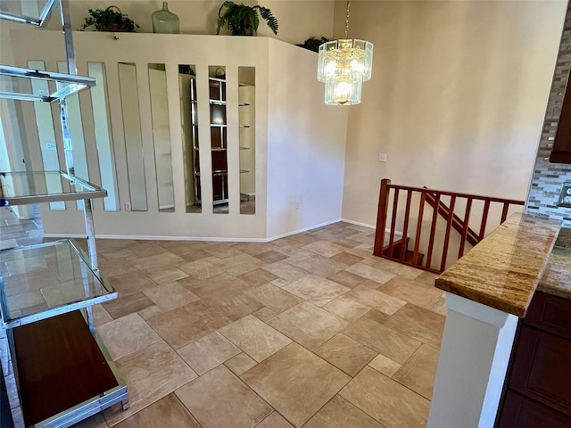 unfurnished dining area featuring a chandelier