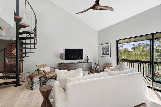 living room with ceiling fan, high vaulted ceiling, and light hardwood / wood-style floors