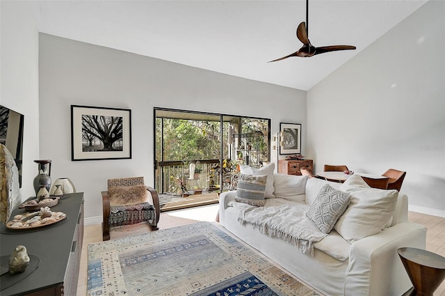 living room featuring light hardwood / wood-style floors, high vaulted ceiling, and ceiling fan