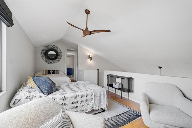 bedroom featuring hardwood / wood-style flooring, ceiling fan, and lofted ceiling