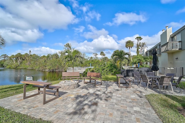 view of patio / terrace with a water view and an outdoor fire pit