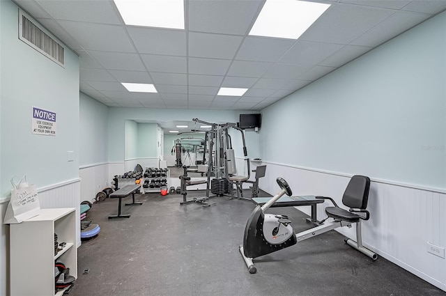 exercise room featuring a drop ceiling